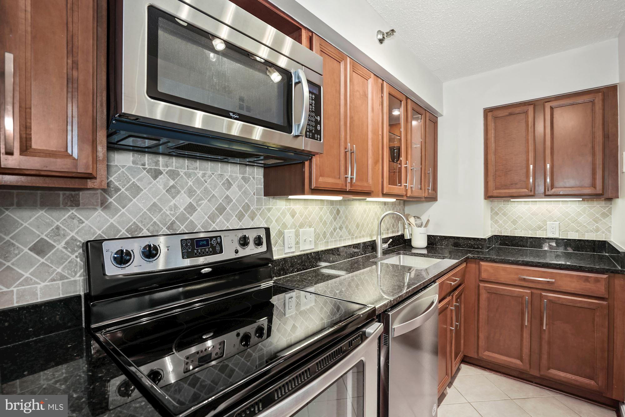 1301 North Courthouse Road, Unit 801 Arlington, VA 22201 - Photo 13 of 31 SS, granite, backsplash, & under-cabinet lighting