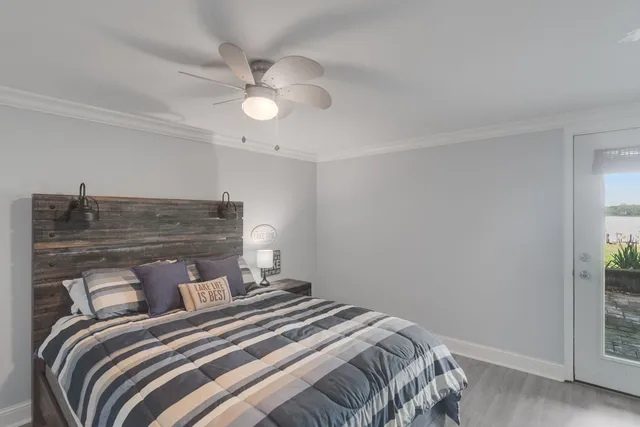 a bedroom with a bed and a chandelier