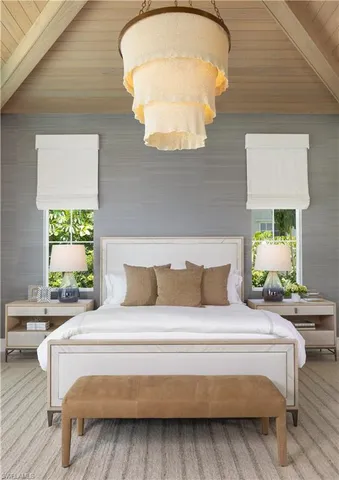a bedroom with a bed and a chandelier