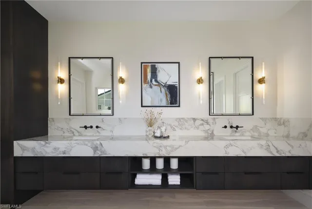 a bathroom with double sink and a mirror