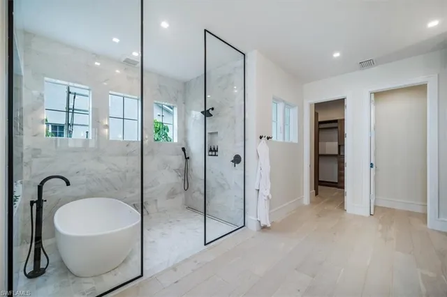 a bathroom with a glass shower door and a sink
