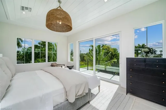 a bedroom with a large bed and a large window