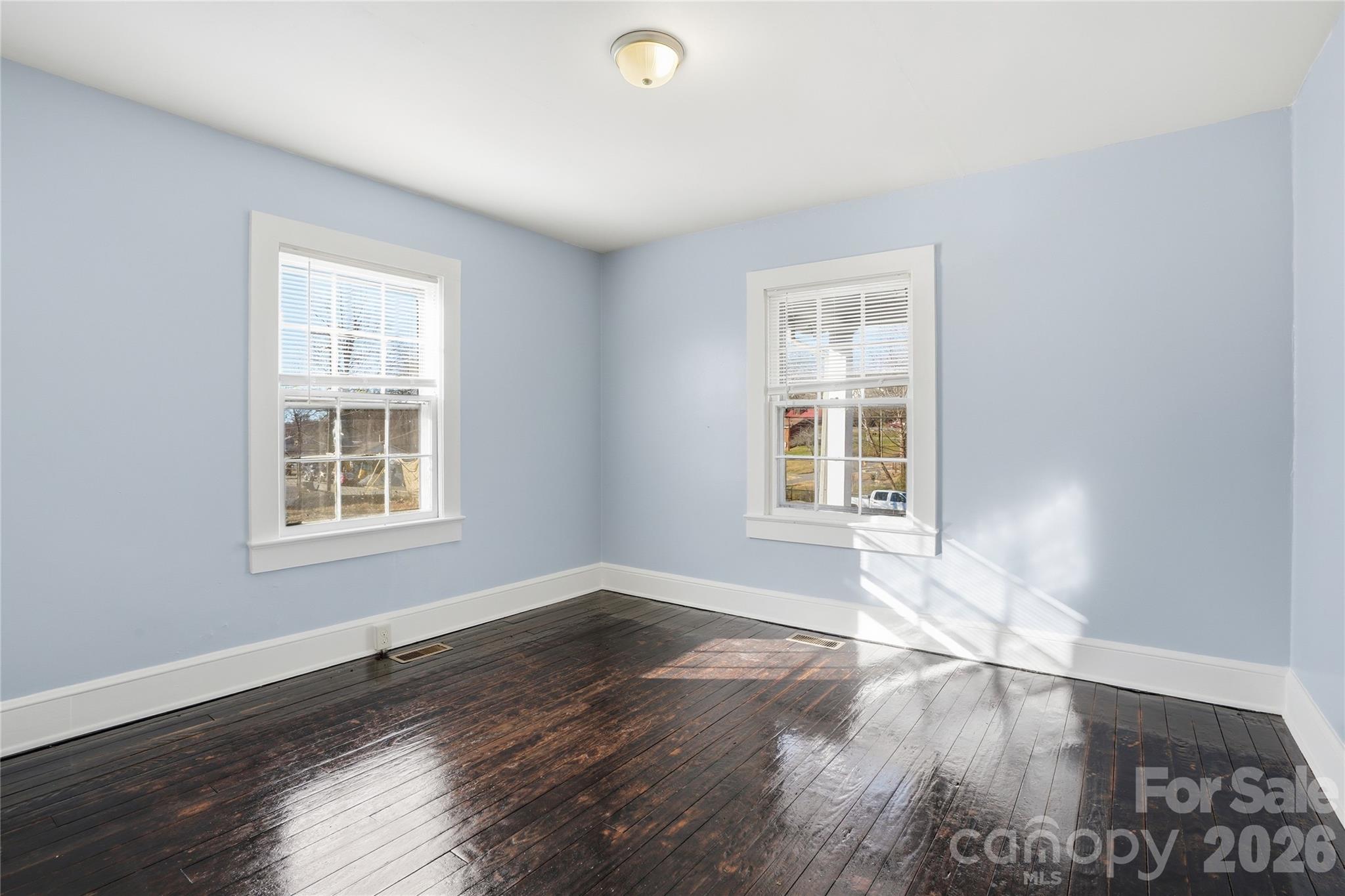 358 North Cleghorn Street Rutherfordton, NC 28139 - Photo 15 of 21 a view of an empty room with wooden floor and a window
