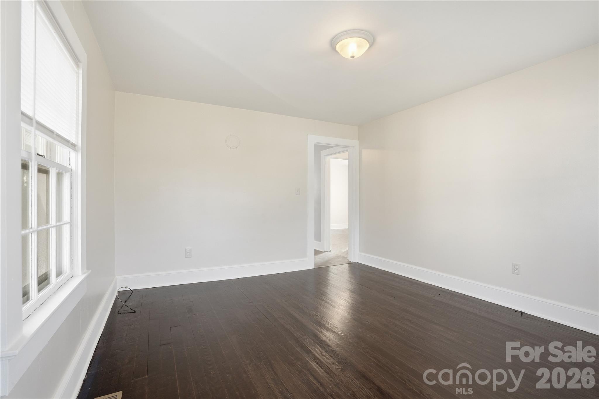 358 North Cleghorn Street Rutherfordton, NC 28139 - Photo 9 of 21 an empty room with wooden floor and windows