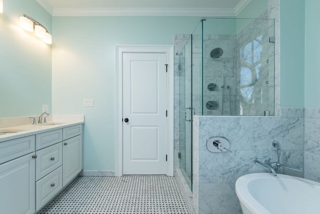 142 Fuller Street, Unit 4 Brookline, MA 02446 - Photo 14 of 40 a bathroom with a tub sink shower and mirror