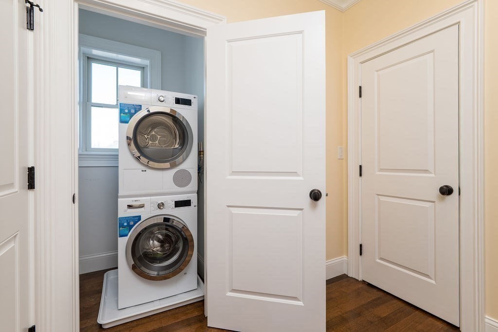 142 Fuller Street, Unit 4 Brookline, MA 02446 - Photo 18 of 40 a view of a hallway with washer and dryer