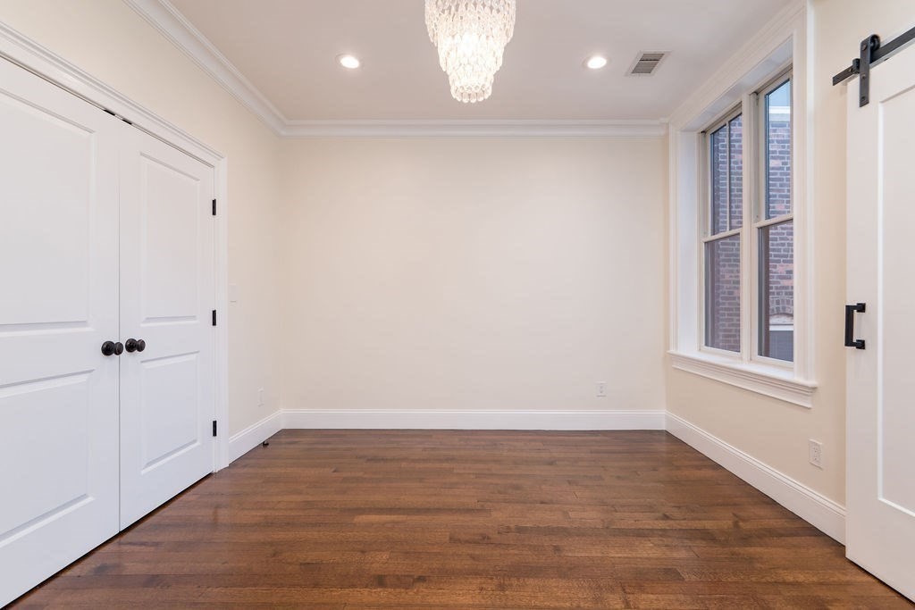 142 Fuller Street, Unit 4 Brookline, MA 02446 - Photo 20 of 40 wooden floor in an empty room with a window