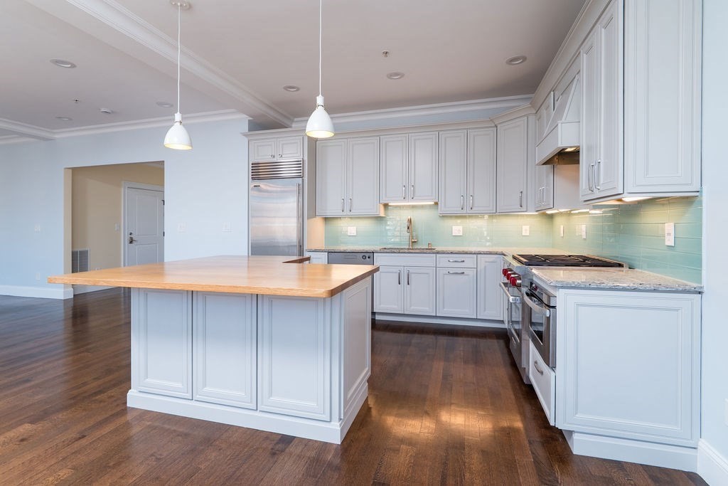 142 Fuller Street, Unit 4 Brookline, MA 02446 - Photo 2 of 40 a kitchen with a sink window and cabinets