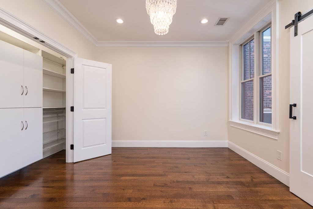 142 Fuller Street, Unit 4 Brookline, MA 02446 - Photo 21 of 40 wooden floor in an empty room with a window