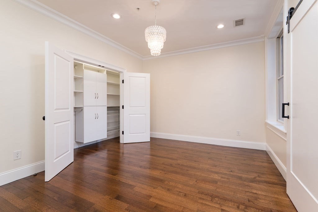 142 Fuller Street, Unit 4 Brookline, MA 02446 - Photo 22 of 40 a view of empty room with wooden floor