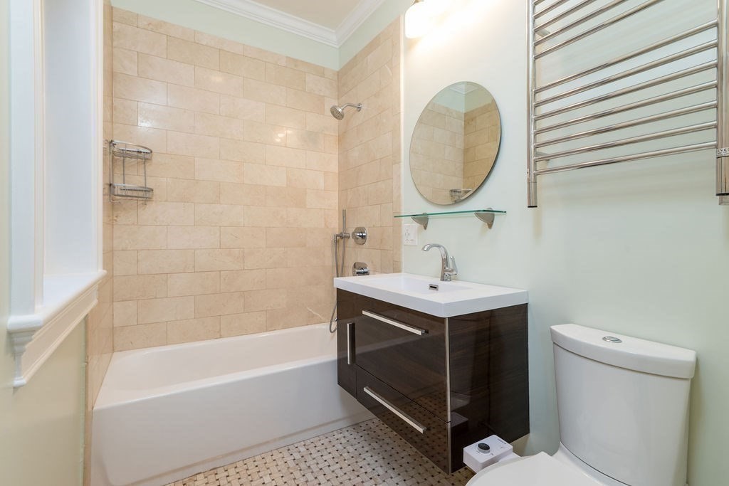 142 Fuller Street, Unit 4 Brookline, MA 02446 - Photo 25 of 40 a bathroom with a sink toilet and a mirror