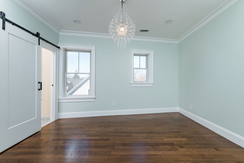 142 Fuller Street, Unit 4 Brookline, MA 02446 - Photo 26 of 40 a view of a room with wooden floor and windows