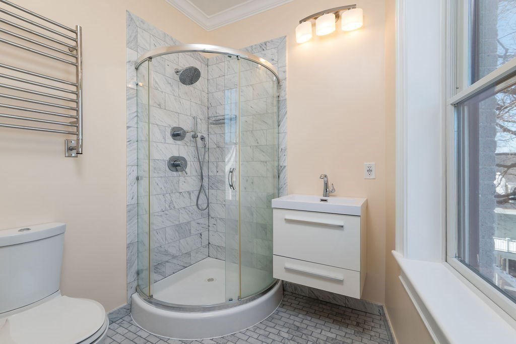 142 Fuller Street, Unit 4 Brookline, MA 02446 - Photo 29 of 40 a bathroom with a sink a toilet and shower