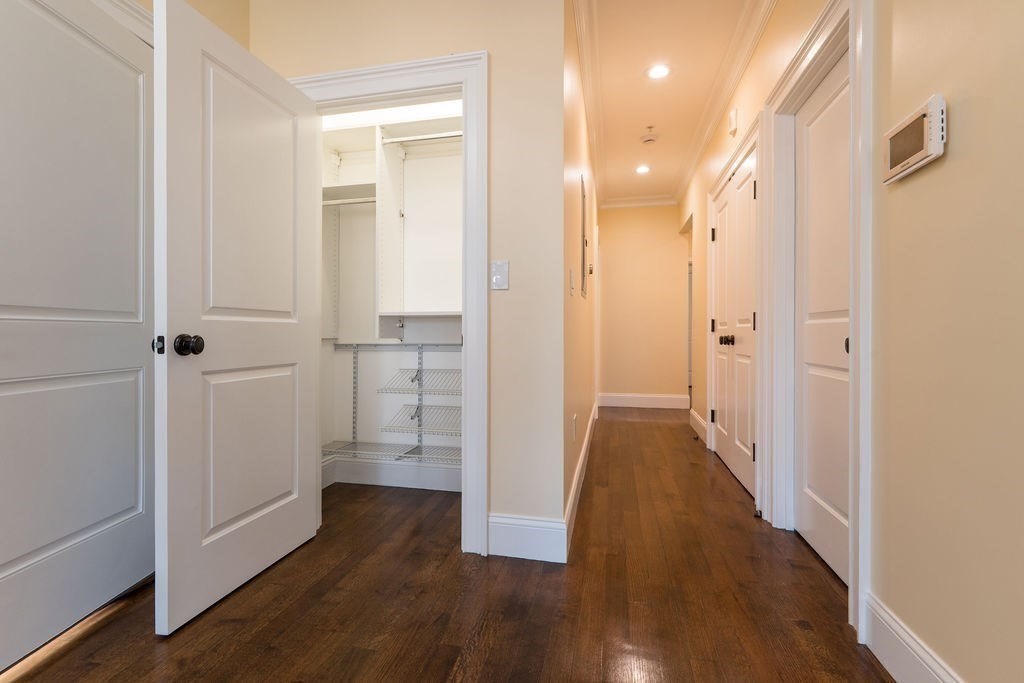 142 Fuller Street, Unit 4 Brookline, MA 02446 - Photo 30 of 40 a view of a hallway with wooden floor