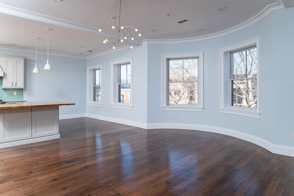 142 Fuller Street, Unit 4 Brookline, MA 02446 - Photo 3 of 40 a view of an empty room with wooden floor and a window