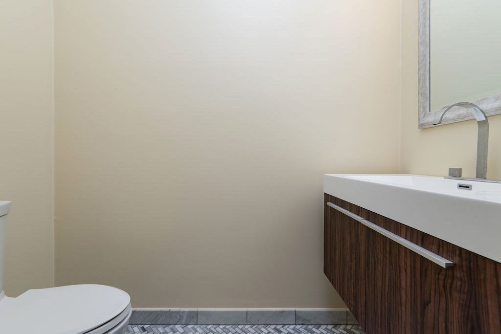 142 Fuller Street, Unit 4 Brookline, MA 02446 - Photo 31 of 40 a bathroom with a sink a toilet and vanity