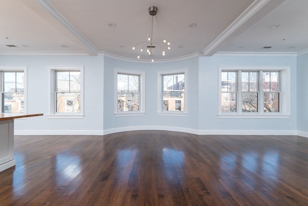 142 Fuller Street, Unit 4 Brookline, MA 02446 - Photo 32 of 40 a view of an empty room with wooden floor and a window