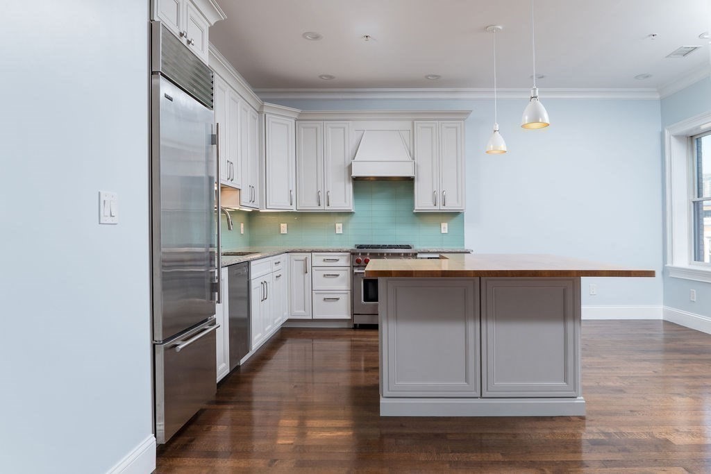 142 Fuller Street, Unit 4 Brookline, MA 02446 - Photo 34 of 40 a kitchen with a refrigerator and cabinets