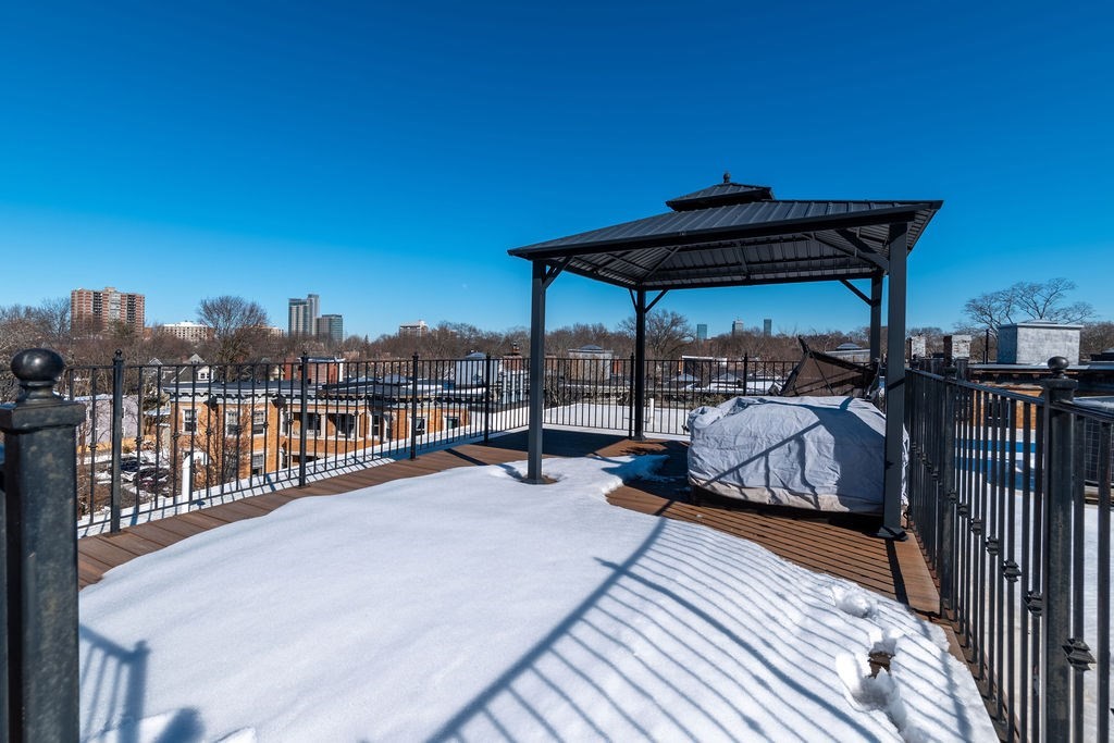 142 Fuller Street, Unit 4 Brookline, MA 02446 - Photo 37 of 40 a view of a balcony with chairs