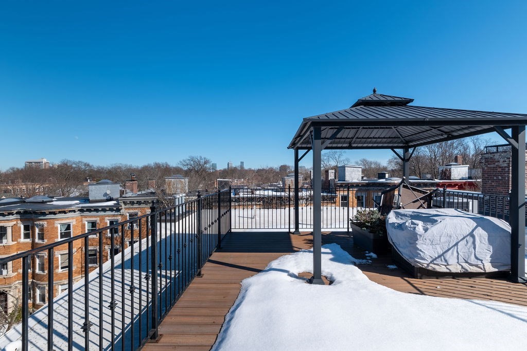 142 Fuller Street, Unit 4 Brookline, MA 02446 - Photo 38 of 40 a view of roof deck with dining table and chairs with wooden floor