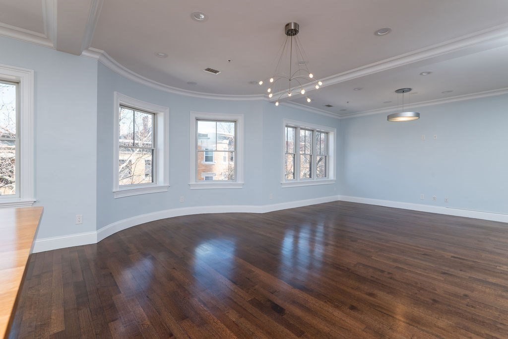 142 Fuller Street, Unit 4 Brookline, MA 02446 - Photo 6 of 40 a view of an empty room with wooden floor and a window