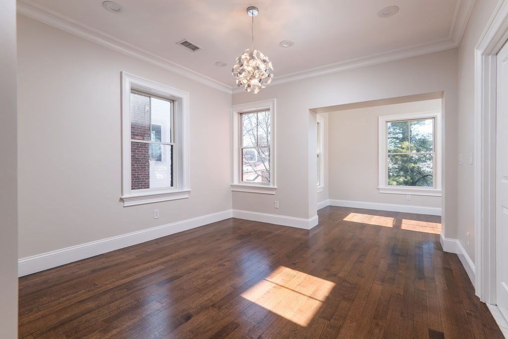 142 Fuller Street, Unit 4 Brookline, MA 02446 - Photo 8 of 40 an empty room with wooden floor and windows