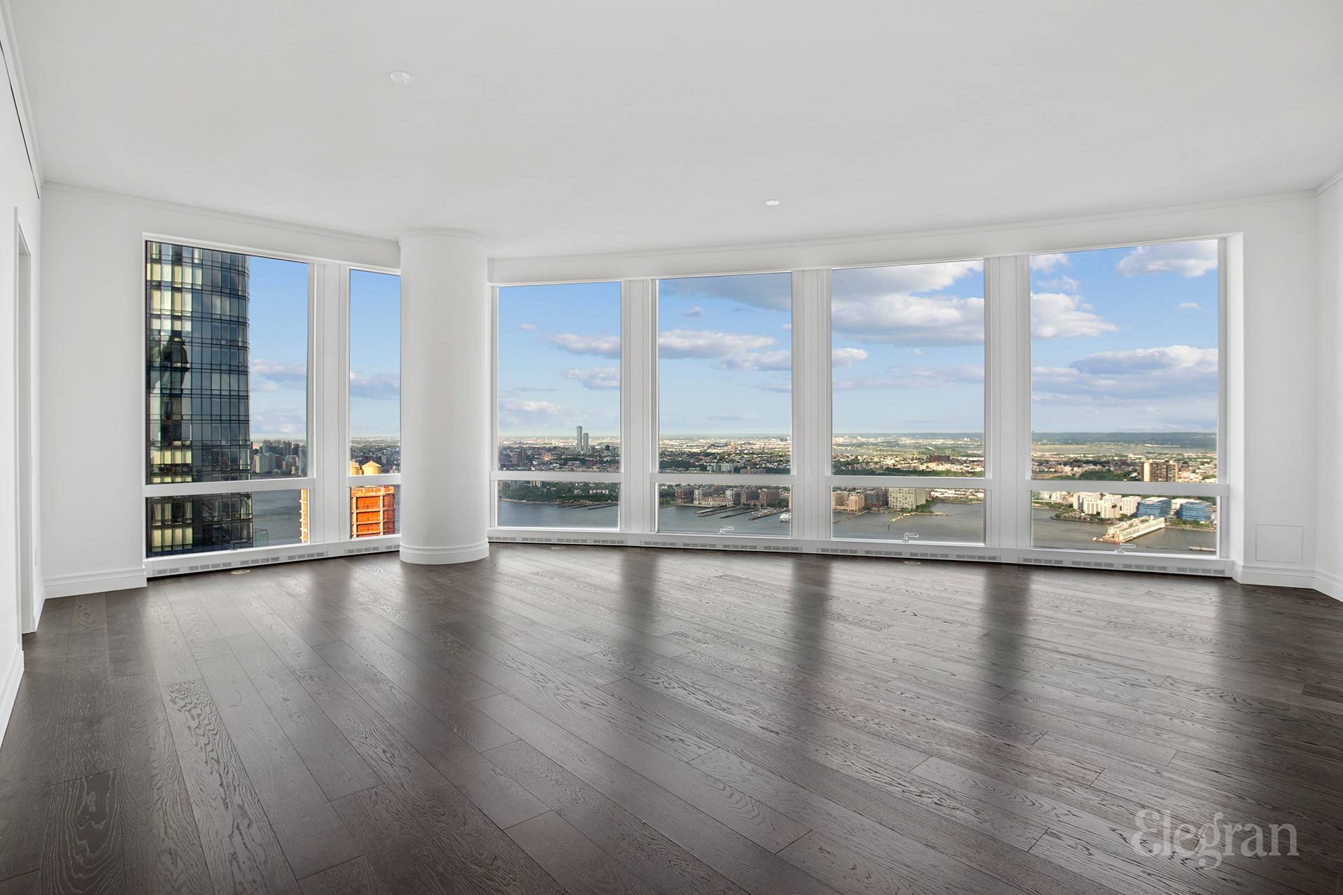 35 Hudson Yards, Unit 6901 Manhattan, NY 10001 - Photo 2 of 24 a view of an empty room with wooden floor and a window