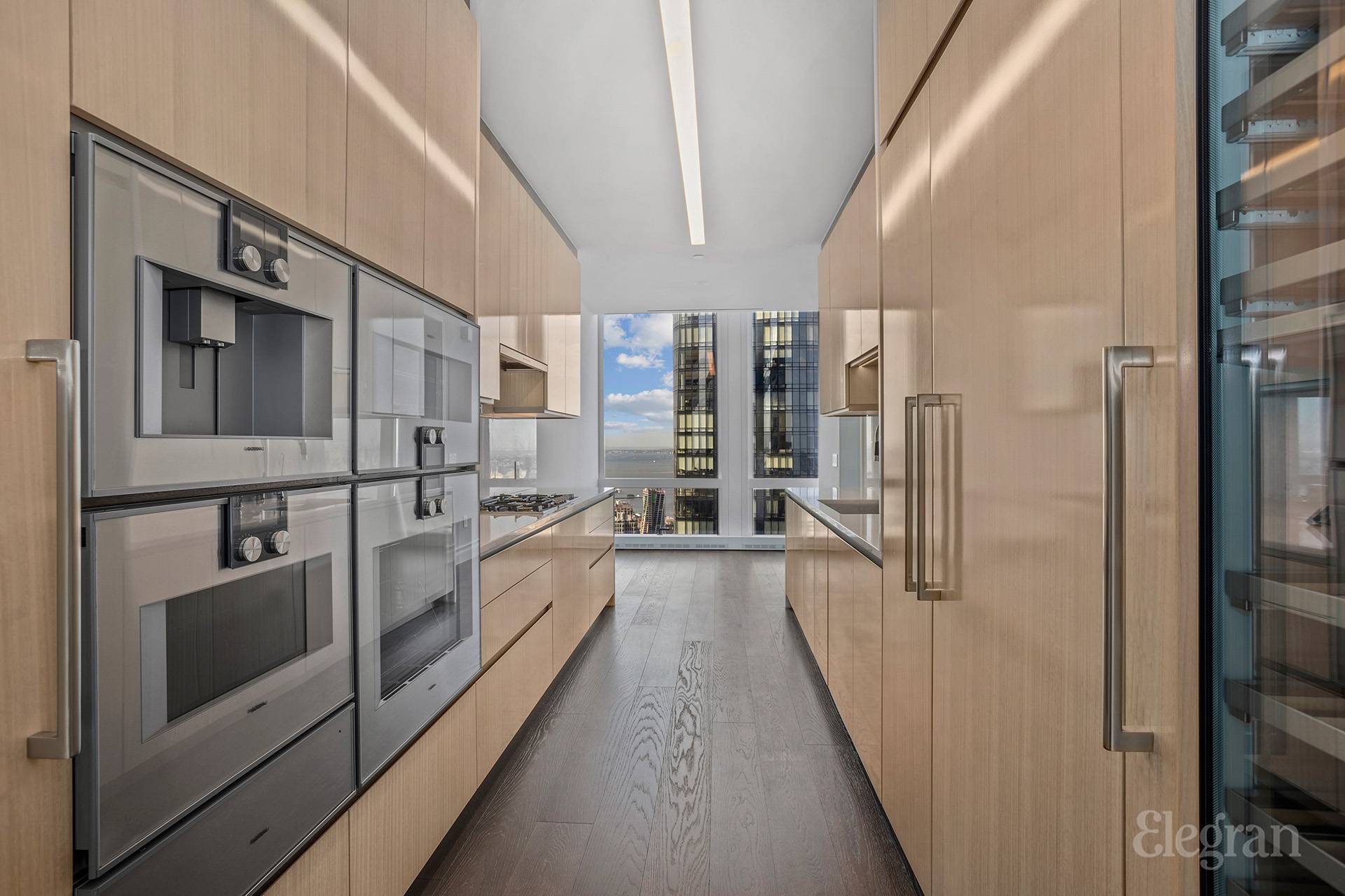 35 Hudson Yards, Unit 6901 Manhattan, NY 10001 - Photo 4 of 24 a view of a kitchen with a refrigerator and a stove