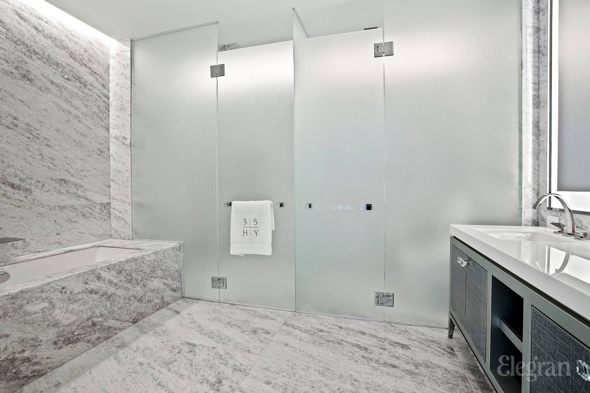 35 Hudson Yards, Unit 6901 Manhattan, NY 10001 - Photo 5 of 24 a bathroom with a sink and a mirror