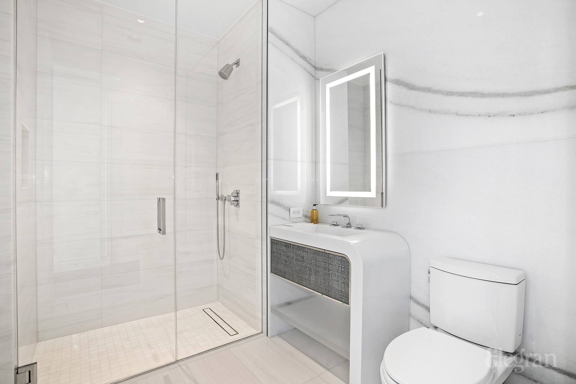 35 Hudson Yards, Unit 6901 Manhattan, NY 10001 - Photo 8 of 24 a bathroom with a granite countertop toilet sink and shower