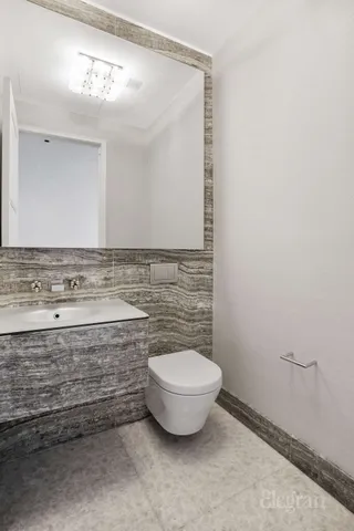 a bathroom with a granite countertop toilet sink and shower