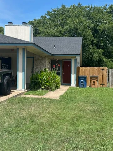 a front view of a house with a garden and plants