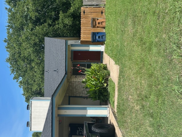 6912 Branchwood Drive, Unit B Austin, TX 78744 - Photo 1 of 11 a front view of a house with a garden and plants