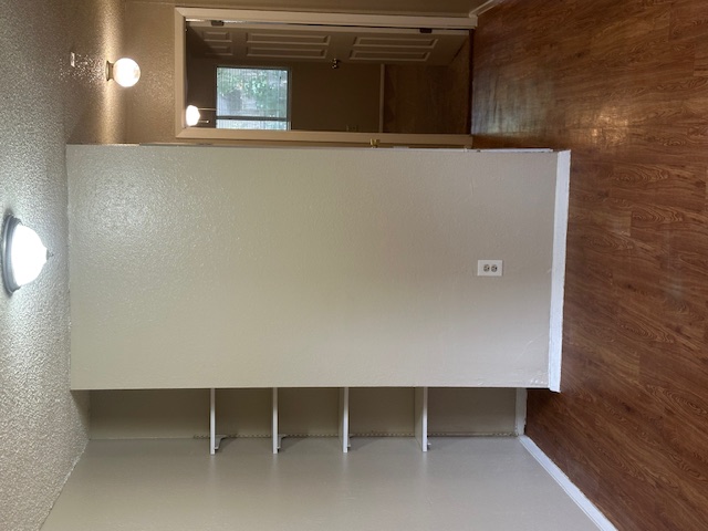 6912 Branchwood Drive, Unit B Austin, TX 78744 - Photo 3 of 11 an empty room with wooden floor and closet