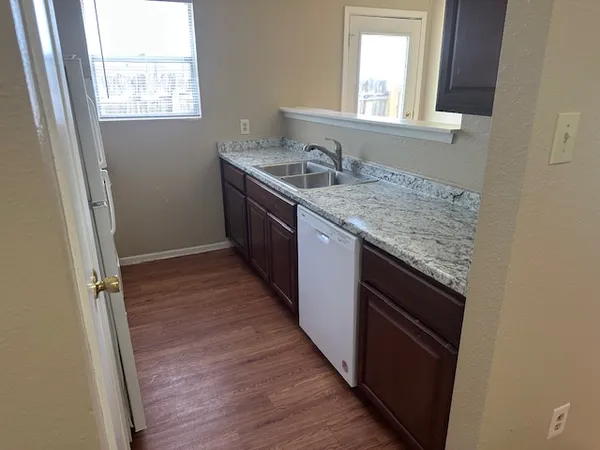 a bathroom with a granite countertop sink and mirror