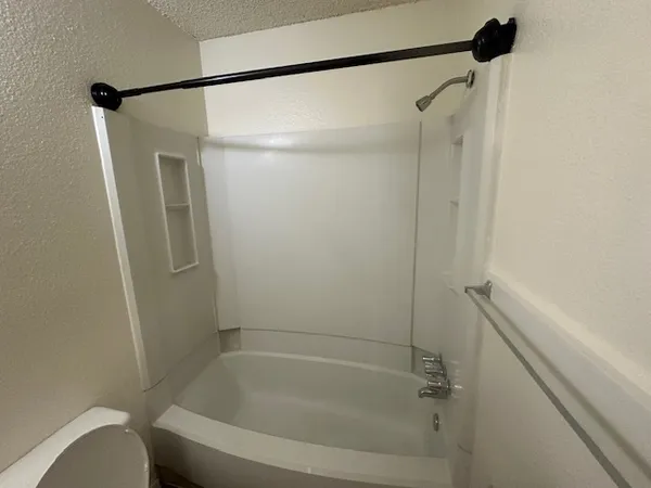 a bathroom with a shower and a bath tub