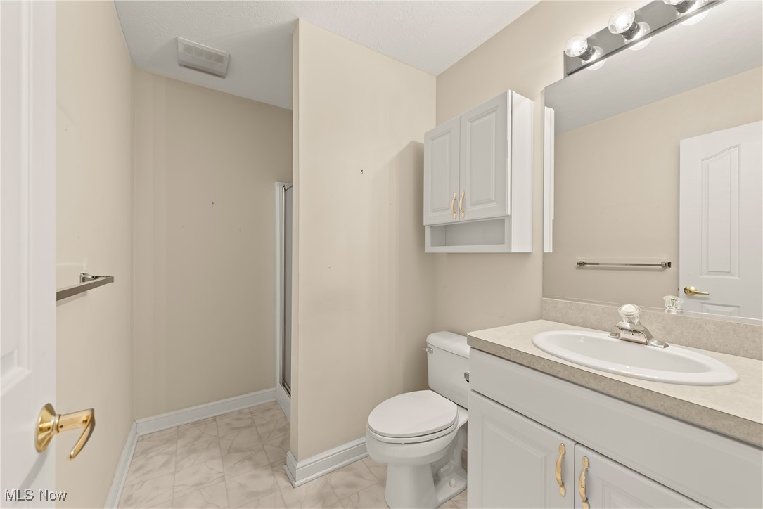 455 Old Reservoir Road Berea, OH 44017 - Photo 35 of 49 Bathroom featuring an enclosed shower, vanity, and toilet