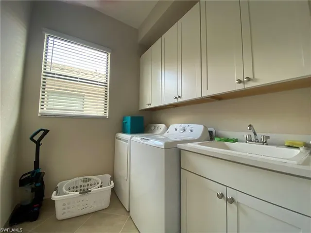 a utility room with a sink washer and dryer