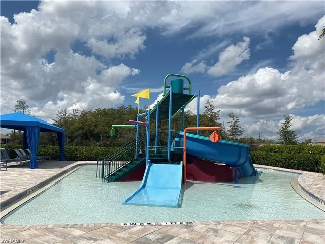 a view of swimming pool with outdoor seating and lake view