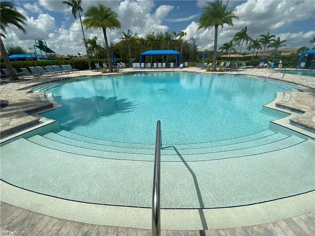 a living room with furniture a chandelier and a fireplace
