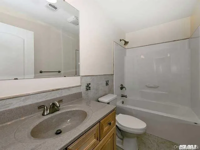 a bathroom with a sink toilet a mirror and shower