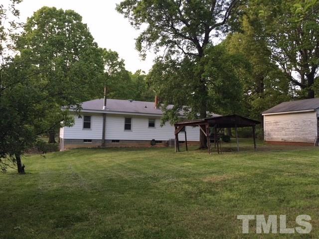 1707 Mason Road Durham, NC 27712 - Photo 11 of 17 a house that is sitting in the grass with large trees