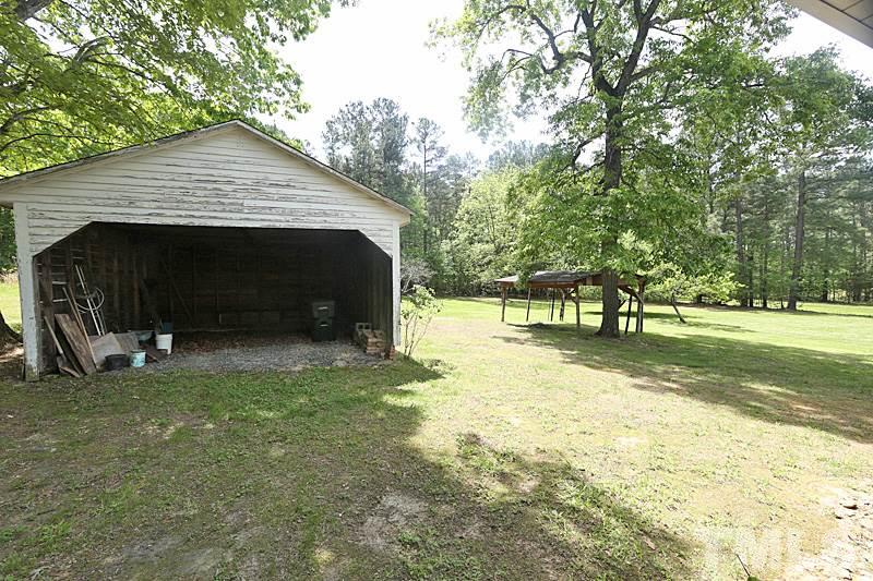 1707 Mason Road Durham, NC 27712 - Photo 17 of 17 a view of a house with backyard and trees