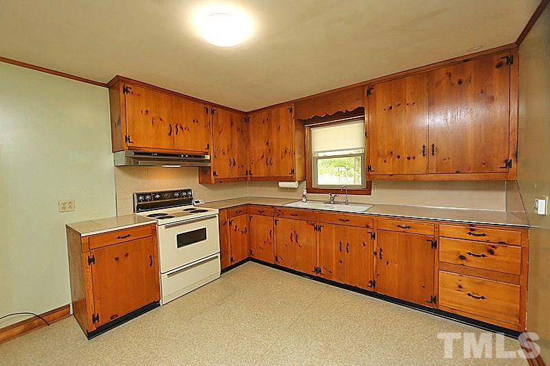 1707 Mason Road Durham, NC 27712 - Photo 4 of 17 a kitchen with stainless steel appliances granite countertop a stove a sink and a microwave