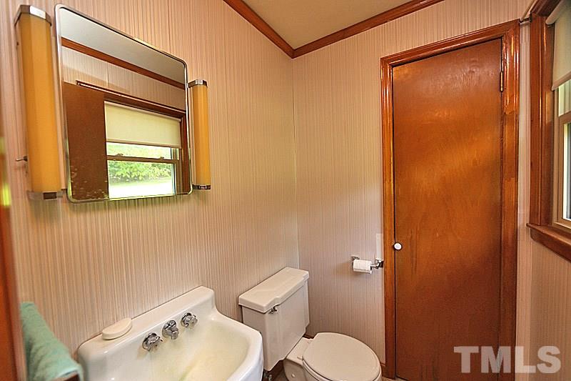 1707 Mason Road Durham, NC 27712 - Photo 6 of 17 a bathroom with a toilet a sink and mirror