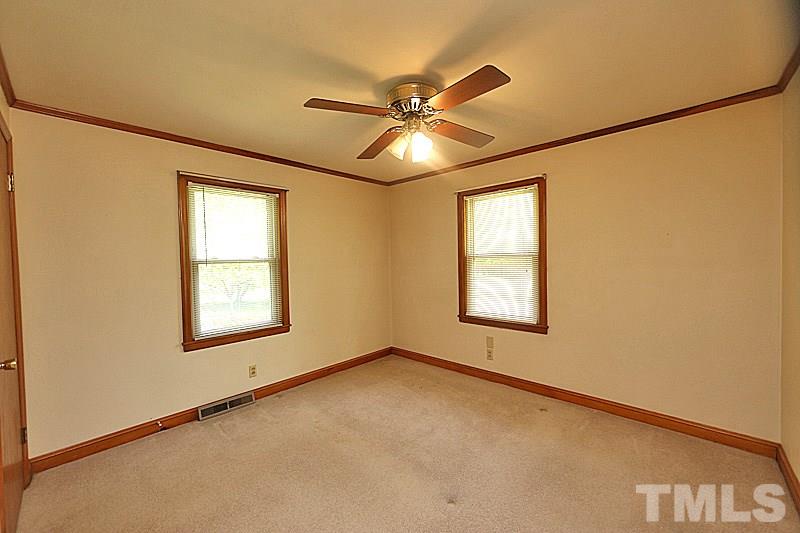1707 Mason Road Durham, NC 27712 - Photo 8 of 17 an empty room with a window and a fan