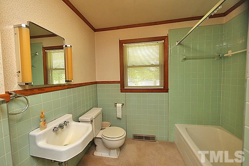 1707 Mason Road Durham, NC 27712 - Photo 9 of 17 a bathroom with a sink mirror and toilet