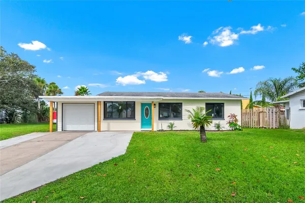 a front view of house with a garden and patio
