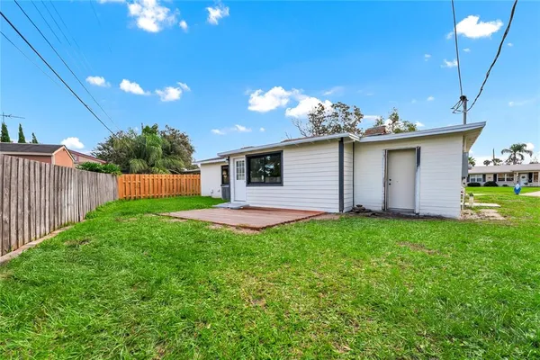 a view of a house with backyard and sitting area