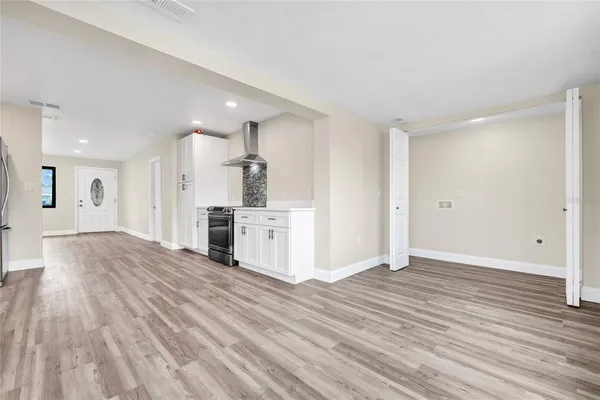 a view of a kitchen with wooden floor